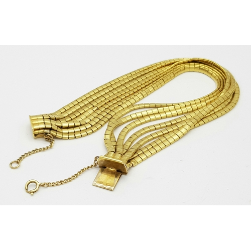 66 - A Beautiful 18K Yellow Gold (tested) Seven Strand Link Bracelet. Clip open design with safety chain.... 