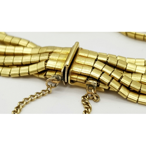 66 - A Beautiful 18K Yellow Gold (tested) Seven Strand Link Bracelet. Clip open design with safety chain.... 