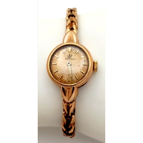 59 - A Vintage Omega 9K Gold Ladies Watch. 9k gold bracelet and case - 18mm. Patinaed dial. Mechanical, h... 
