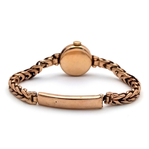 59 - A Vintage Omega 9K Gold Ladies Watch. 9k gold bracelet and case - 18mm. Patinaed dial. Mechanical, h... 