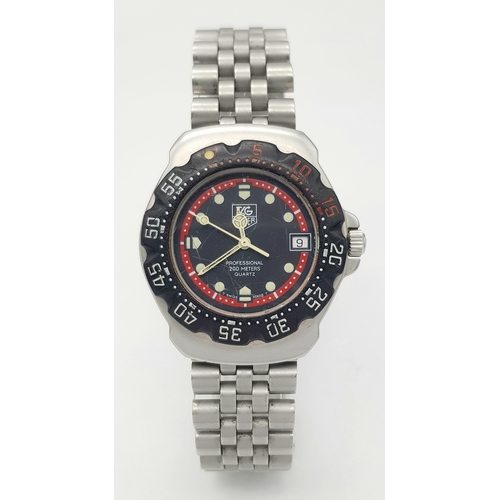 81 - A Vintage Tag Heuer Stainless Steel Formula 1 Midsize Watch. Case - 34mm. Black dial with date windo... 