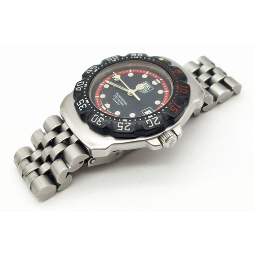 81 - A Vintage Tag Heuer Stainless Steel Formula 1 Midsize Watch. Case - 34mm. Black dial with date windo... 