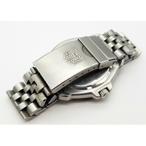 81 - A Vintage Tag Heuer Stainless Steel Formula 1 Midsize Watch. Case - 34mm. Black dial with date windo... 