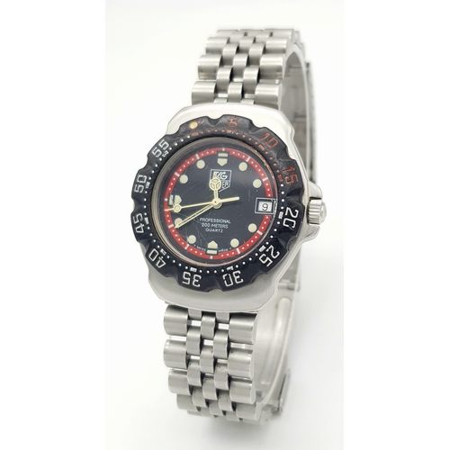 81 - A Vintage Tag Heuer Stainless Steel Formula 1 Midsize Watch. Case - 34mm. Black dial with date windo... 