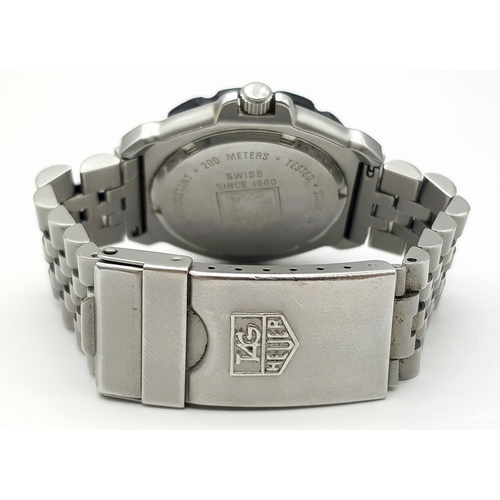 81 - A Vintage Tag Heuer Stainless Steel Formula 1 Midsize Watch. Case - 34mm. Black dial with date windo... 