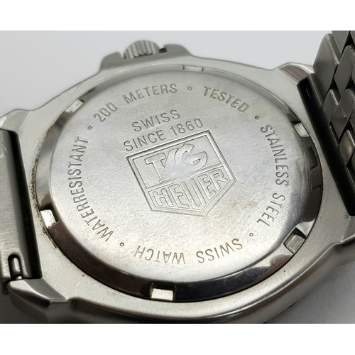81 - A Vintage Tag Heuer Stainless Steel Formula 1 Midsize Watch. Case - 34mm. Black dial with date windo... 