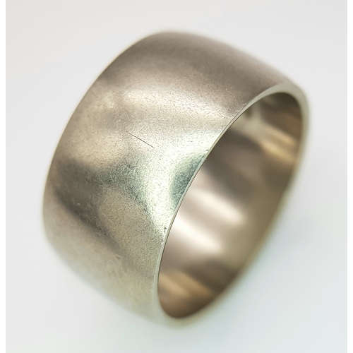 74 - A 9K White Gold Band Ring. 9mm width. Size N. 7.19g. R-6152571.