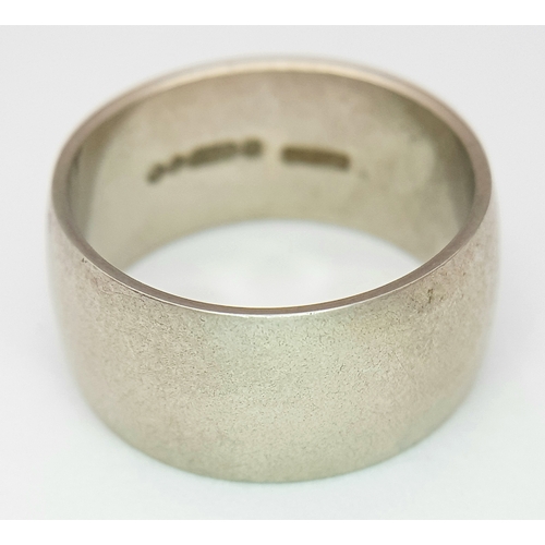 74 - A 9K White Gold Band Ring. 9mm width. Size N. 7.19g. R-6152571.