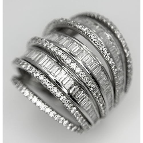 146 - An 18K White Gold and Diamond Dress Ring. Layered form with 291 round brilliant and baguette cut dia... 
