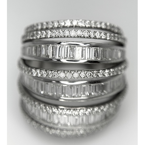 146 - An 18K White Gold and Diamond Dress Ring. Layered form with 291 round brilliant and baguette cut dia... 