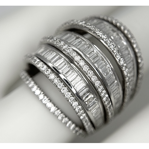 146 - An 18K White Gold and Diamond Dress Ring. Layered form with 291 round brilliant and baguette cut dia... 