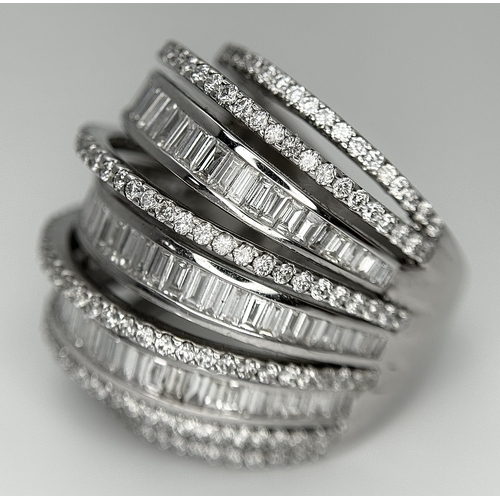 146 - An 18K White Gold and Diamond Dress Ring. Layered form with 291 round brilliant and baguette cut dia... 