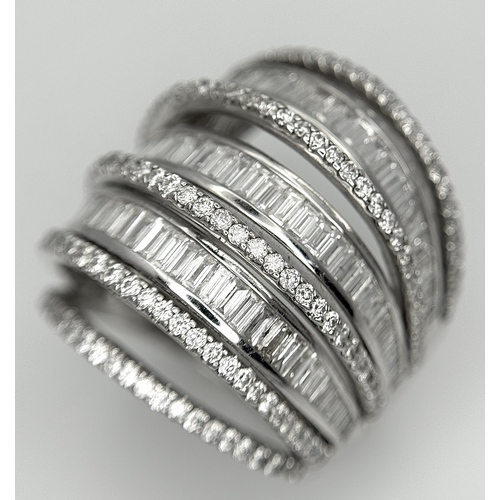 146 - An 18K White Gold and Diamond Dress Ring. Layered form with 291 round brilliant and baguette cut dia... 