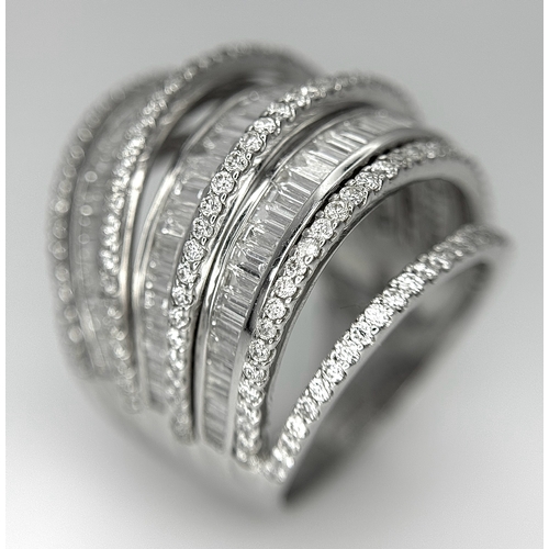 146 - An 18K White Gold and Diamond Dress Ring. Layered form with 291 round brilliant and baguette cut dia... 