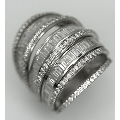 146 - An 18K White Gold and Diamond Dress Ring. Layered form with 291 round brilliant and baguette cut dia... 