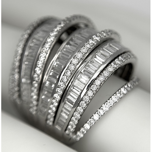 146 - An 18K White Gold and Diamond Dress Ring. Layered form with 291 round brilliant and baguette cut dia... 