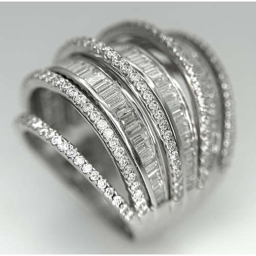 146 - An 18K White Gold and Diamond Dress Ring. Layered form with 291 round brilliant and baguette cut dia... 