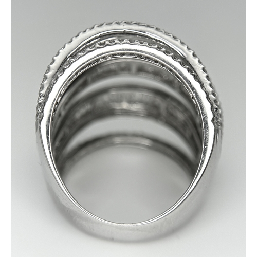 146 - An 18K White Gold and Diamond Dress Ring. Layered form with 291 round brilliant and baguette cut dia... 
