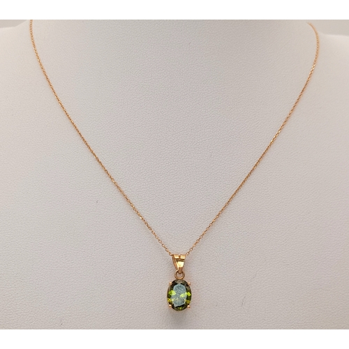 174 - An 18K Yellow Gold and Peridot Pendant on an 18K Yellow Gold Disappearing Necklace. 15mm and 42cm. 2... 