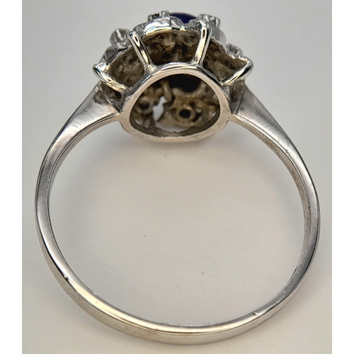 151 - An 18K WHITE GOLD FANCY FLORAL DESIGN DIAMOND SET RING. BEAUTIFUL PIECE. 4.7G TOTAL WEIGHT, SIZE R 1... 