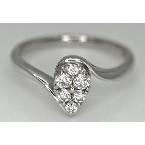 144 - AN 18K WHITE GOLD DIAMOND SET, PEAR SHAPED CROSSOVER RING. 0.25CTW. 3.7G. SIZE P. SC-5086.