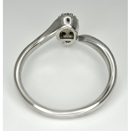144 - AN 18K WHITE GOLD DIAMOND SET, PEAR SHAPED CROSSOVER RING. 0.25CTW. 3.7G. SIZE P. SC-5086.