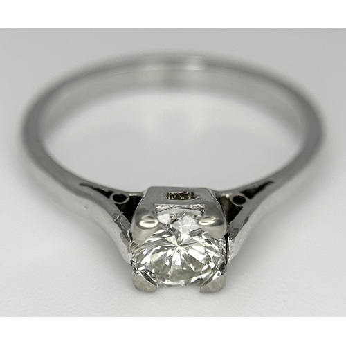170 - An 18K White Gold Diamond Solitaire Ring. 0.50ct round brilliant cut diamond. SI1, Slightly champagn... 