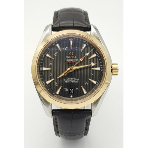 An Omega Seamaster Aqua Terra Automatic Gents Watch. Model - 231.23.43.22.06.001. Black leather strap. Stainless steel and gold case - 43mm. Black dial. Skeleton back. In good condition and working order. Comes with box and papers. STK023213