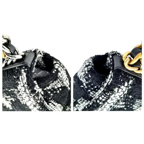 969 - A Chanel Black and White Tweed Flap Bag. Quilted tweed exterior with gold toned hardware, leather-in... 