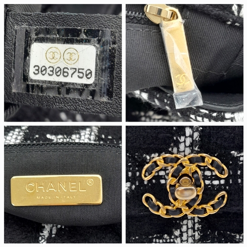 969 - A Chanel Black and White Tweed Flap Bag. Quilted tweed exterior with gold toned hardware, leather-in... 