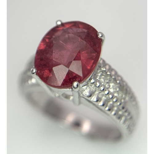 988 - An 18K White Gold, Royal Ruby and Diamond Ring. A 5.038 Madagascan oval cut Royal ruby with 0.084ctw... 