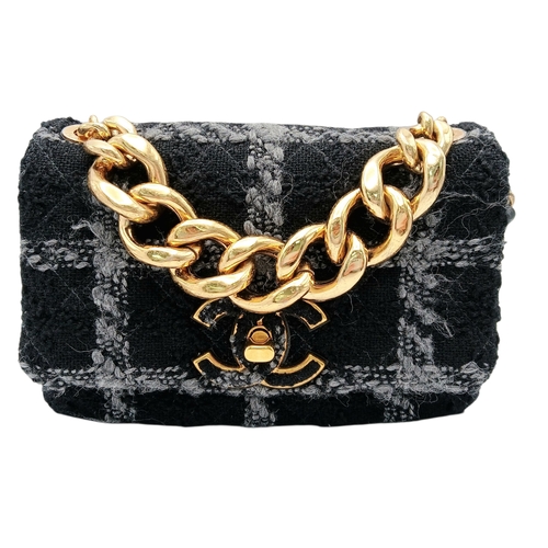 60 - A Chanel Black and Grey Tweed Flap Bag. Wool tweed exterior with gold-toned hardware, chain top hand... 