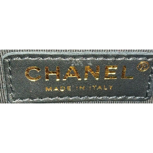 60 - A Chanel Black and Grey Tweed Flap Bag. Wool tweed exterior with gold-toned hardware, chain top hand... 