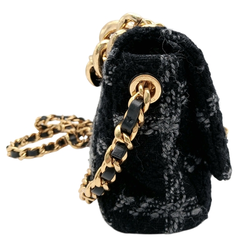 60 - A Chanel Black and Grey Tweed Flap Bag. Wool tweed exterior with gold-toned hardware, chain top hand... 