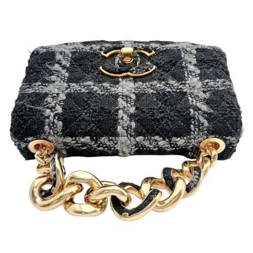 60 - A Chanel Black and Grey Tweed Flap Bag. Wool tweed exterior with gold-toned hardware, chain top hand... 