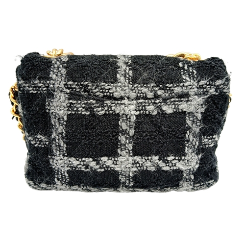 60 - A Chanel Black and Grey Tweed Flap Bag. Wool tweed exterior with gold-toned hardware, chain top hand... 