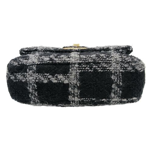60 - A Chanel Black and Grey Tweed Flap Bag. Wool tweed exterior with gold-toned hardware, chain top hand... 