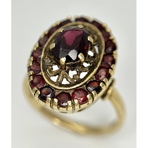 161 - An impressive 9 CARAT GOLD GARNET DRESS RING. 4 .7 Grams. Size M.
