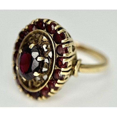 161 - An impressive 9 CARAT GOLD GARNET DRESS RING. 4 .7 Grams. Size M.