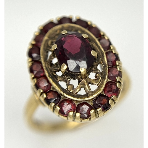 161 - An impressive 9 CARAT GOLD GARNET DRESS RING. 4 .7 Grams. Size M.