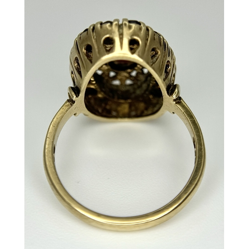 161 - An impressive 9 CARAT GOLD GARNET DRESS RING. 4 .7 Grams. Size M.