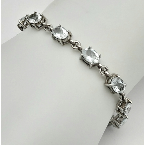 168 - Stunning SILVER and BLUE TOPAZ TENNIS BRACELET from The Genuine Gemstone Company. Having Oval Cut To... 