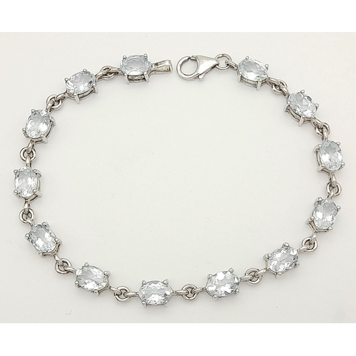 168 - Stunning SILVER and BLUE TOPAZ TENNIS BRACELET from The Genuine Gemstone Company. Having Oval Cut To... 