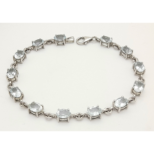 168 - Stunning SILVER and BLUE TOPAZ TENNIS BRACELET from The Genuine Gemstone Company. Having Oval Cut To... 