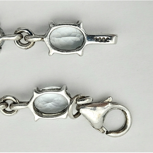 168 - Stunning SILVER and BLUE TOPAZ TENNIS BRACELET from The Genuine Gemstone Company. Having Oval Cut To... 