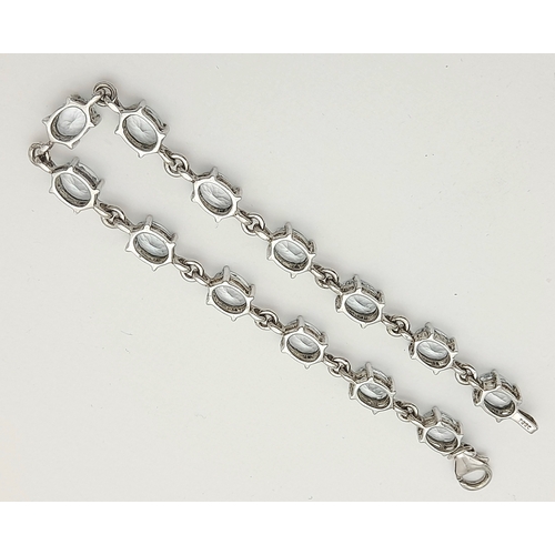 168 - Stunning SILVER and BLUE TOPAZ TENNIS BRACELET from The Genuine Gemstone Company. Having Oval Cut To... 