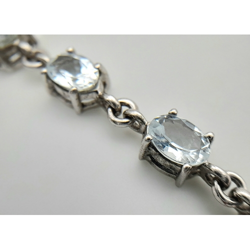 168 - Stunning SILVER and BLUE TOPAZ TENNIS BRACELET from The Genuine Gemstone Company. Having Oval Cut To... 