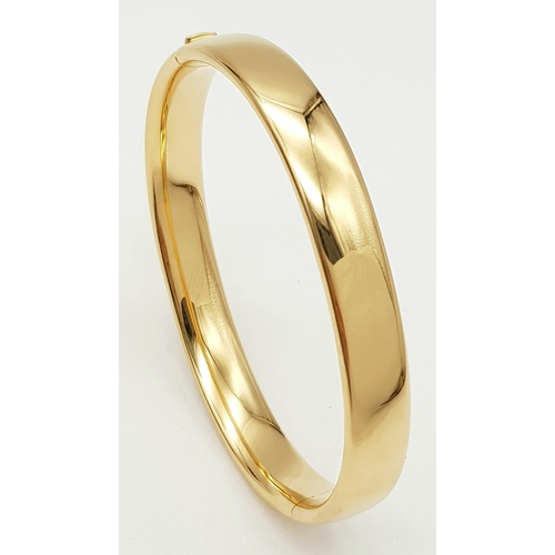 141 - A Bucherer 18K yellow gold solid bangle. Total weight 24.3G. Diameter 6.8cm. Comes with original pre... 