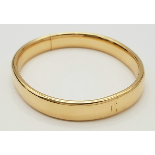 141 - A Bucherer 18K yellow gold solid bangle. Total weight 24.3G. Diameter 6.8cm. Comes with original pre... 