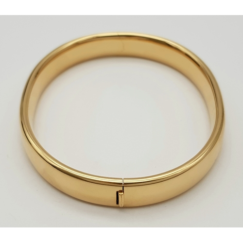 141 - A Bucherer 18K yellow gold solid bangle. Total weight 24.3G. Diameter 6.8cm. Comes with original pre... 